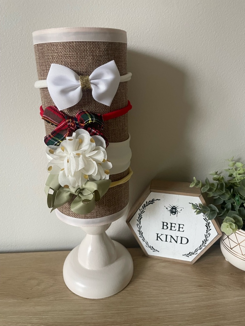 White and Green Decorative Headband Display with Floral Accents